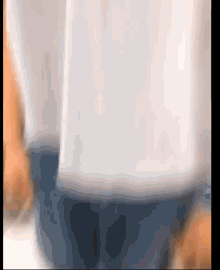 a person wearing a white shirt and blue jeans