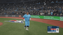 a baseball player in a blue jays uniform is running on a field
