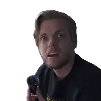 a man with a beard is holding a microphone and making a funny face