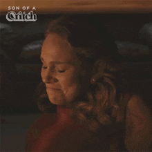 a woman is covering her mouth with her hand and the words son of a critch are behind her