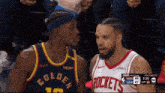 two basketball players from the golden state warriors and the rockets are talking