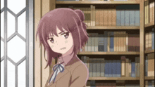 a girl in a brown suit stands in front of a bookcase