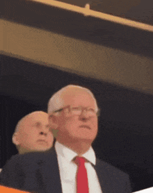 a man in a suit and tie is looking up
