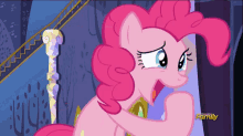 a pink pony from my little pony is standing in front of a purple wall