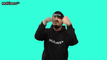 a man wearing a black hoodie and a black beanie with the word multivers on it