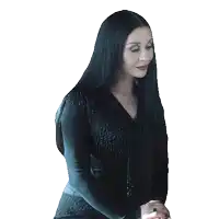 a woman with long black hair is smiling and wearing a black dress