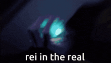 a man in a suit and hat is holding a diamond and the words rei in the real are on the bottom