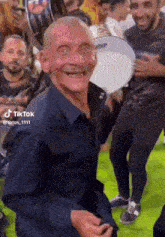 a man in a black shirt is dancing in a crowd