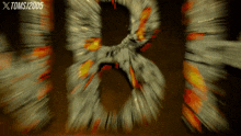 a blurry image of the letters b and r with a toms / 2005 logo in the corner