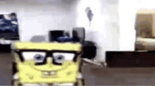 a spongebob cartoon character wearing glasses is sitting in a chair in a room .