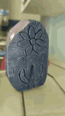 a soap bar with a flower carved into it