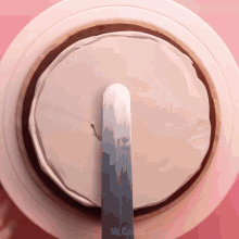 a spatula is being used to frost a cake with mr.cakes written on the bottom right