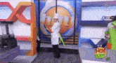 a man in a chef 's hat is dancing in front of a blender on a tv show