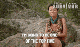 a woman is sitting on a rock with the words " i 'm going to be one of the top five " above her