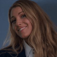 a close up of a woman 's face with long blonde hair