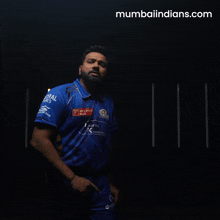 a man in a blue shirt that says mumbaiindians.com on the bottom