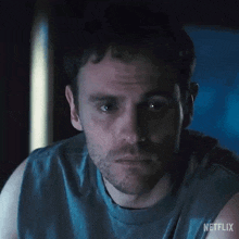 a close up of a man 's face in a dark room with a netflix logo in the corner .