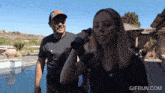 a gif from gifrun.com shows a man and a woman standing next to each other