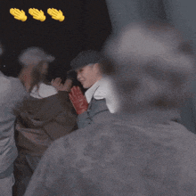 a man wearing a hat and red gloves is being applauded
