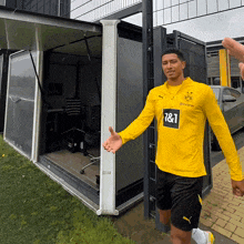 a man wearing a yellow shirt that says 7 & 1 on the front