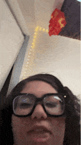 a woman wearing glasses and a headband is making a face