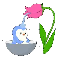 a penguin is taking a bath in a bowl of water next to a pink flower