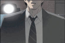a man in a suit and tie stands in front of a brick wall