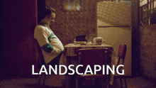 a man sits on a swing with the word landscaping written below him