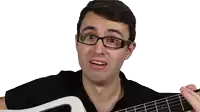 a man with braces on his teeth holds a guitar