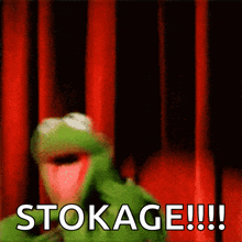 kermit the frog is standing in front of a red curtain and says stokage !!!