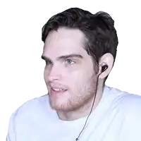 a man with a beard wearing a white shirt and earphones