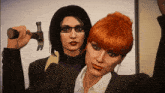 a woman holding a hammer next to another woman with glasses