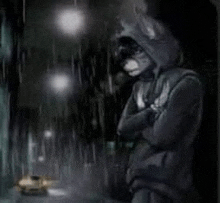 a man in a hooded jacket is standing in the rain looking out a window .