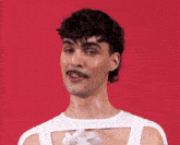 a man with a mustache is wearing a white shirt and a necklace