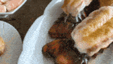a white plate topped with lobster tails on a table