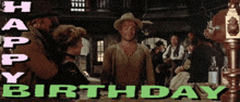 a man in a cowboy hat stands in front of a sign that says " happy birthday "
