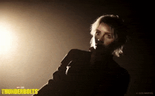 a woman in a dark room with the word thunderbolts on the bottom right