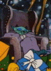 a cartoon character is sitting in a chair next to a blue gift box with a bow .
