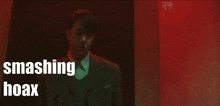 a man in a suit and tie is being smashed with the words smashing hoax above him