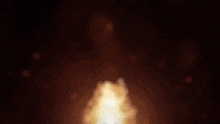 a close up of a fire with smoke coming out of it