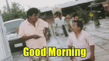 two men standing next to each other with the words " good morning " written in yellow