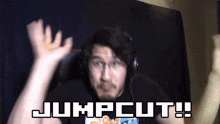 a man wearing headphones and a shirt that says jumpcut on it
