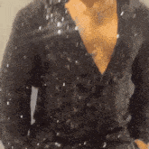 a close up of a person 's chest in a black shirt
