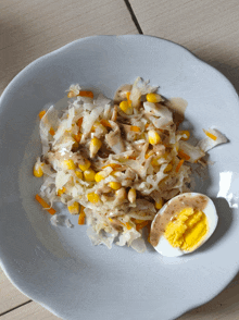 a white plate topped with a salad and an egg