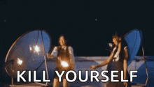 a woman is smiling and says `` kill yourself '' while standing in front of a tent .