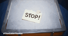 a stop sign is taped to a piece of paper on a table