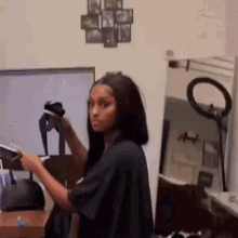 a woman is standing in front of a mirror holding a pair of socks .