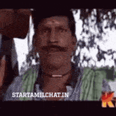 a man with a mustache is on a tv screen with the words starttamilchat.in