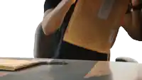 a person is holding a brown envelope with a label that says ' united states postal service '