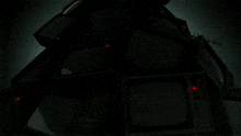 a bunch of televisions are stacked on top of each other and one of the televisions has the letter t on it
